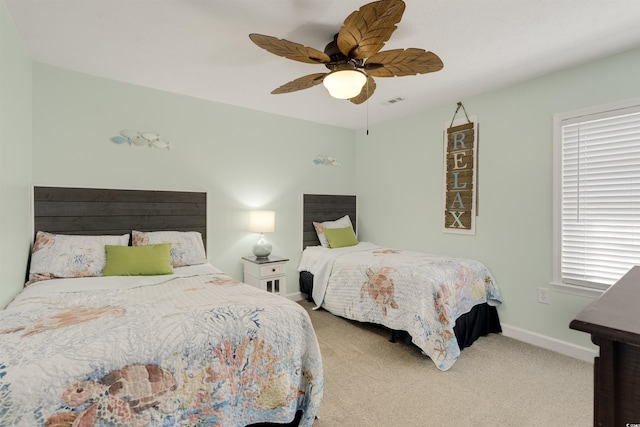 bedroom featuring visible vents, carpet, baseboards, and ceiling fan