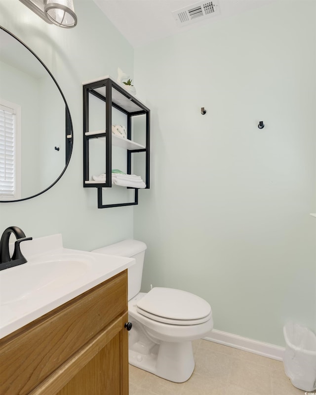 bathroom featuring vanity, baseboards, visible vents, tile patterned floors, and toilet