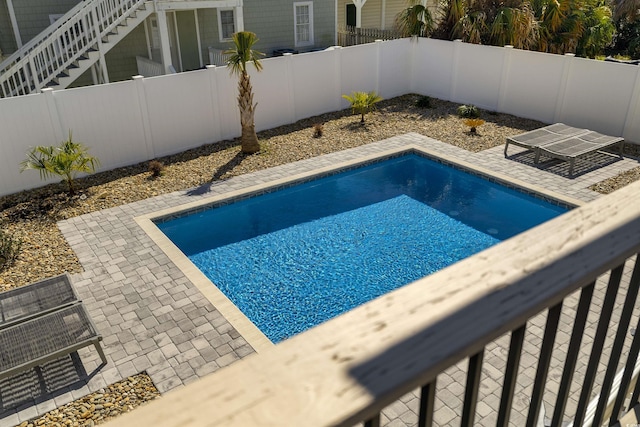 view of pool with a patio, a fenced backyard, and a fenced in pool