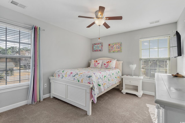 bedroom with visible vents, light carpet, and multiple windows