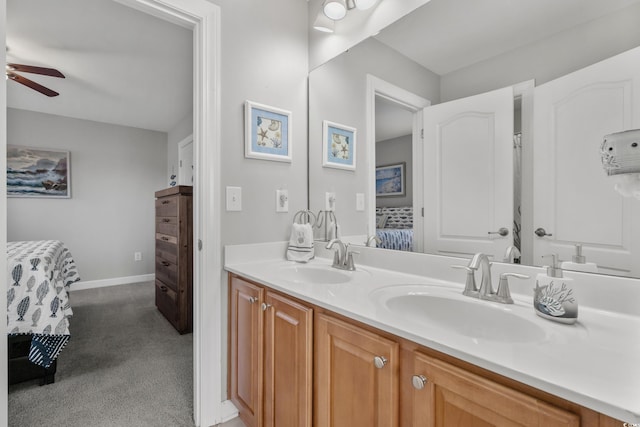 full bath featuring a sink, double vanity, ceiling fan, and ensuite bath