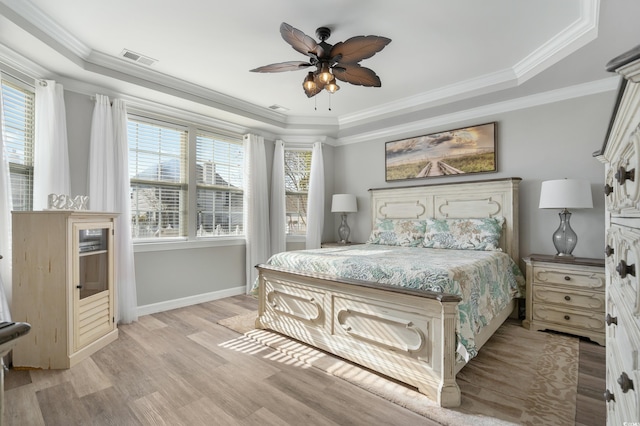 bedroom featuring visible vents, light wood-style floors, ornamental molding, ceiling fan, and baseboards