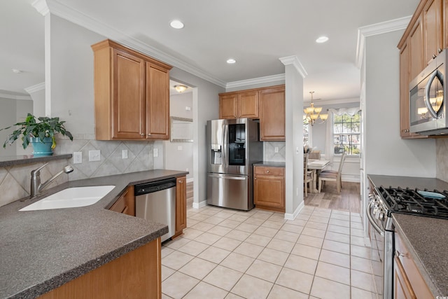 kitchen with crown molding, light tile patterned floors, dark countertops, appliances with stainless steel finishes, and a sink