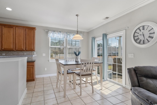 dining room featuring visible vents, crown molding, baseboards, and light tile patterned floors