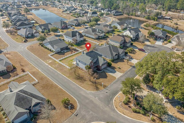 drone / aerial view featuring a residential view and a water view