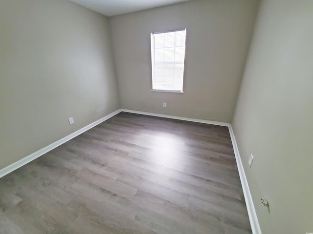 empty room with wood finished floors and baseboards