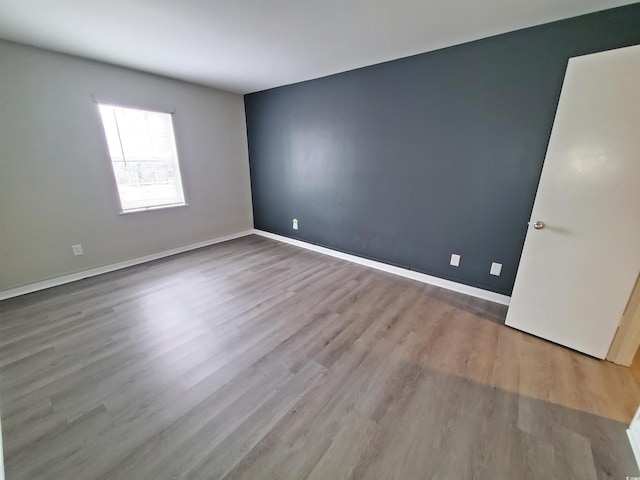 empty room with wood finished floors and baseboards