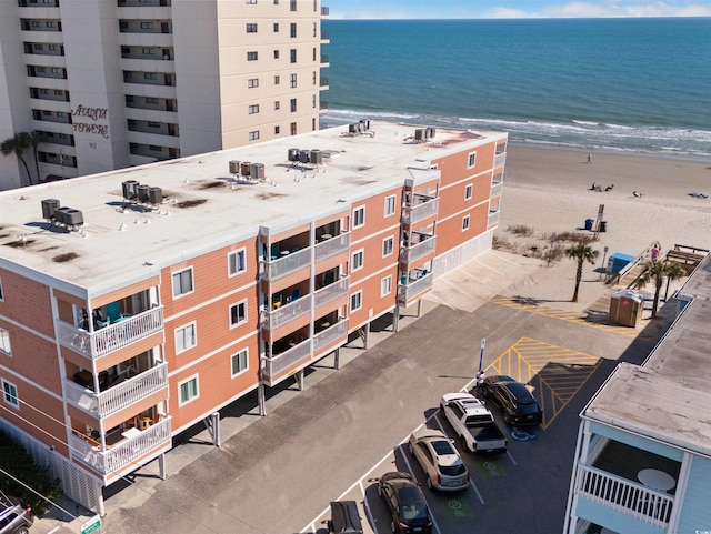 exterior space featuring a beach view and a water view