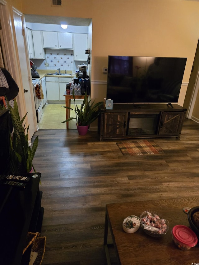 living room with visible vents and wood finished floors