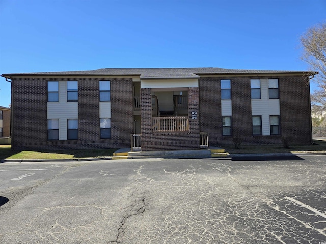 view of building exterior with uncovered parking