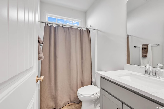 full bathroom featuring a shower with curtain, vanity, toilet, and wood finished floors