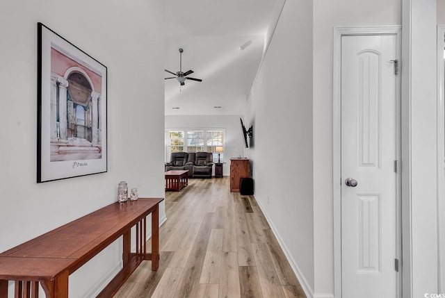 hallway with light wood finished floors and baseboards