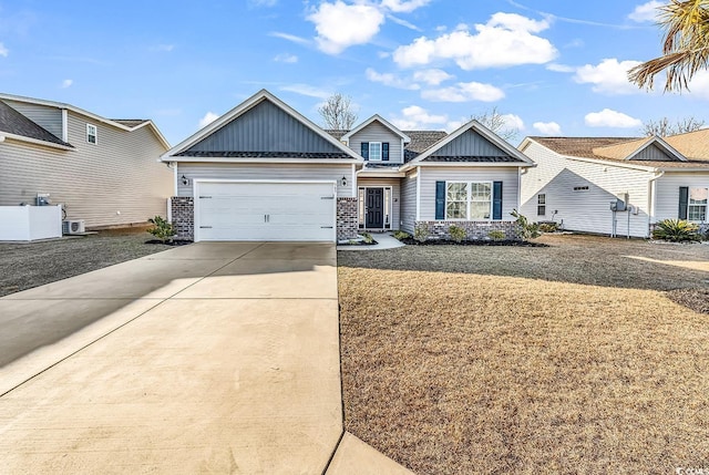 view of front of property with concrete driveway, a front lawn, board and batten siding, and an attached garage