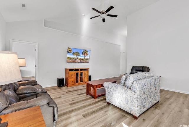 living room with light wood-style floors, ceiling fan, high vaulted ceiling, and baseboards