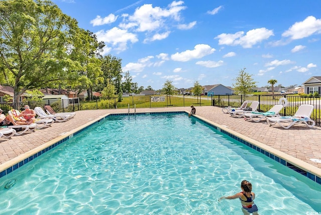 community pool featuring a patio area and fence