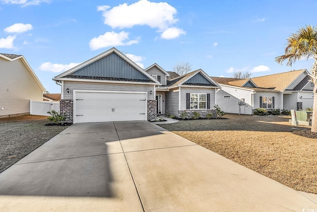 view of front facade featuring brick siding, concrete driveway, board and batten siding, fence, and a garage