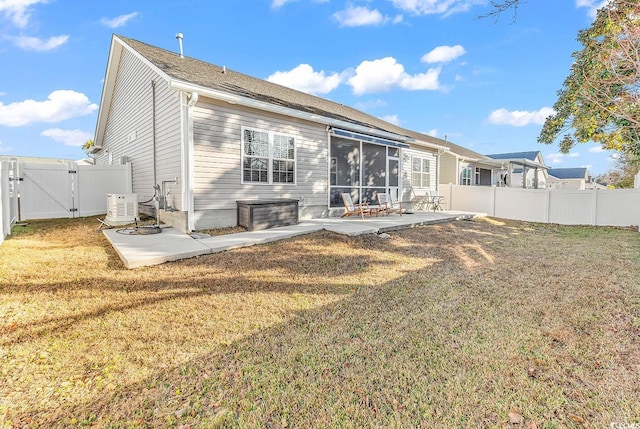 back of property featuring a sunroom, a fenced backyard, a gate, a yard, and a patio area