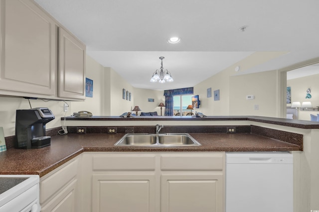 kitchen with white dishwasher, a sink, white cabinetry, dark countertops, and a notable chandelier