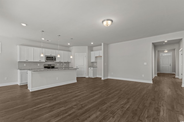 1204 NW Calabash Station Blvd, Calabash, NC 28467 - kitchen with stainless steel appliances, an island with sink, white cabinets, and recessed lighting