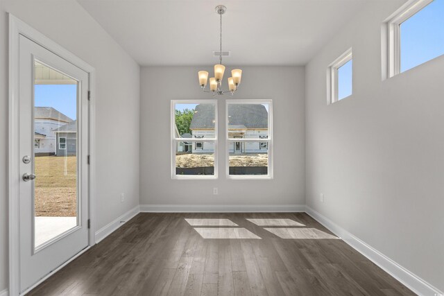 1204 NW Calabash Station Blvd, Calabash, NC 28467 - unfurnished dining area featuring baseboards, a notable chandelier, and dark wood-style flooring