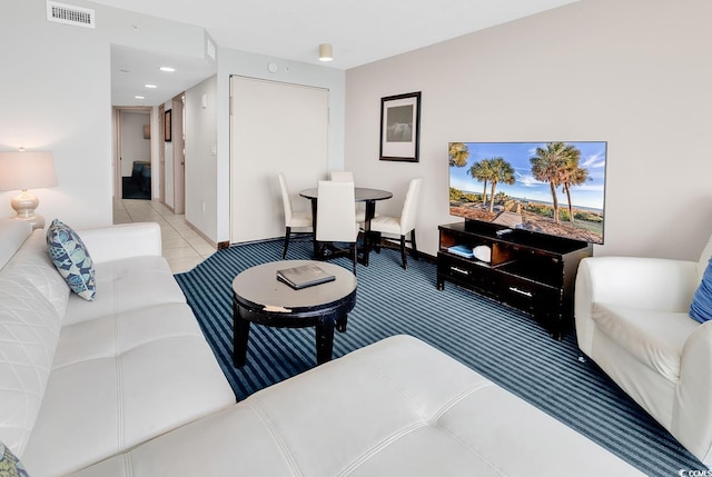 carpeted living room with recessed lighting, visible vents, and tile patterned floors