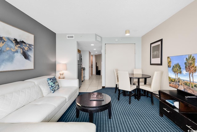 living room featuring carpet floors and visible vents