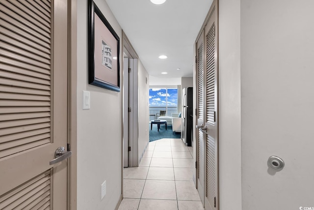 corridor with recessed lighting and light tile patterned floors