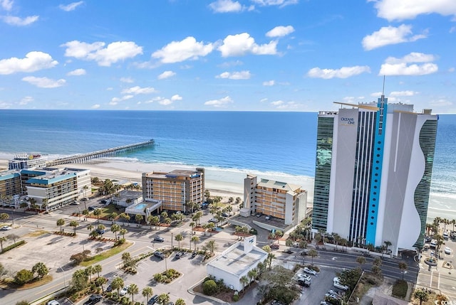 birds eye view of property with a water view and a view of the beach