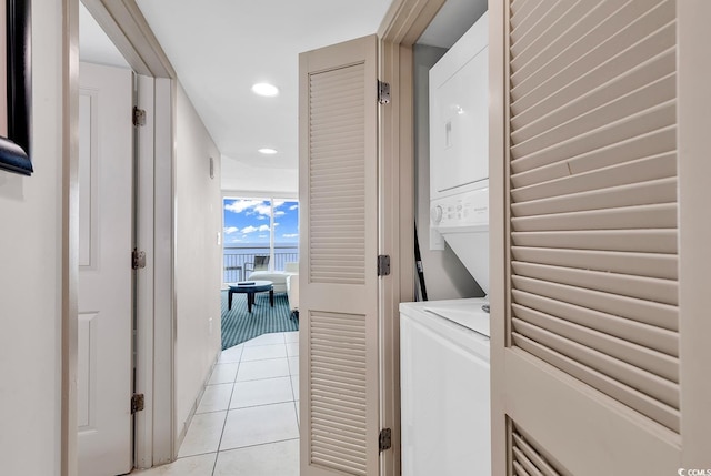 washroom featuring laundry area, recessed lighting, light tile patterned flooring, and stacked washer / drying machine