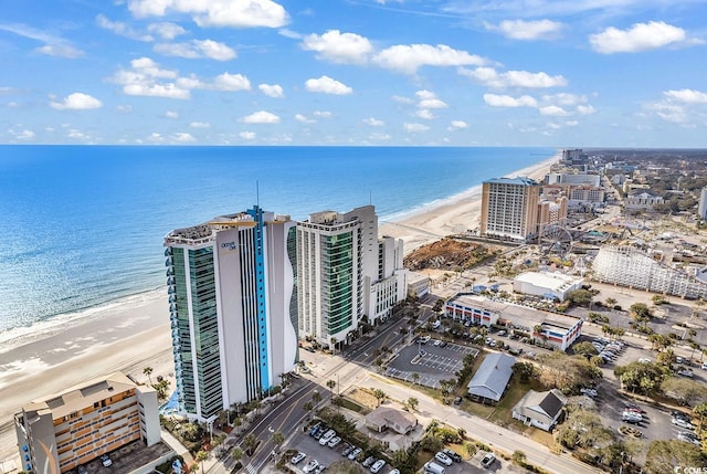 bird's eye view featuring a water view, a view of city, and a beach view