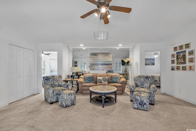 living area featuring carpet, baseboards, a ceiling fan, and recessed lighting