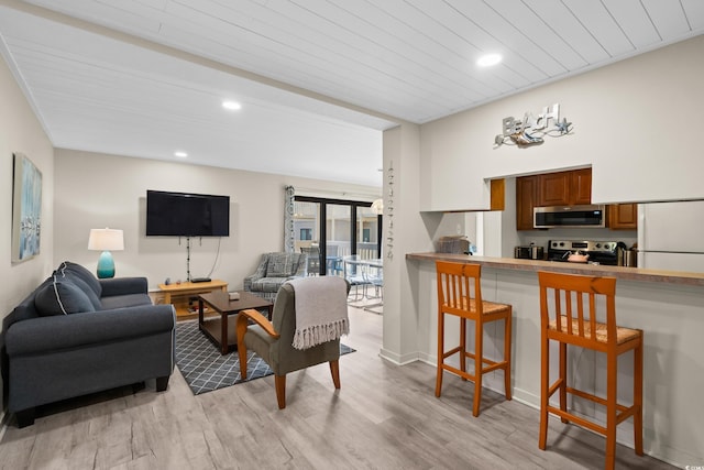 living area featuring recessed lighting, wood ceiling, and light wood-style flooring