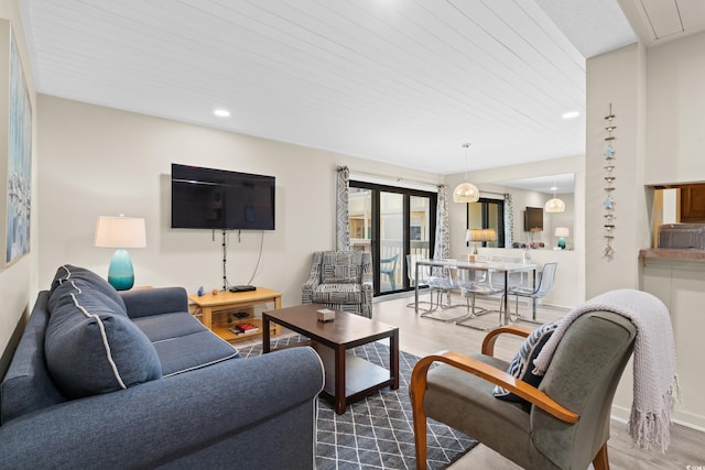 living area with recessed lighting, baseboards, and wood finished floors