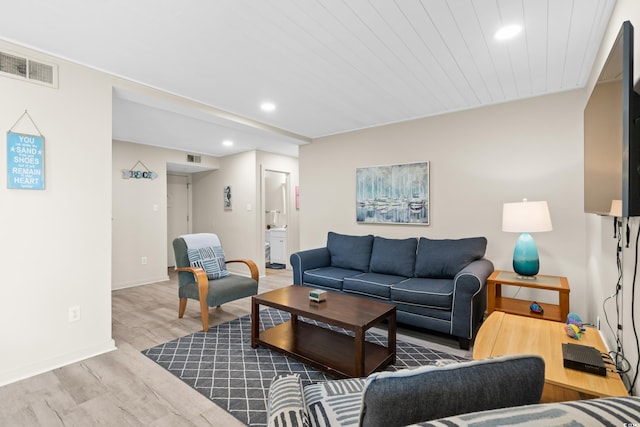 living area with recessed lighting, wood finished floors, visible vents, and baseboards