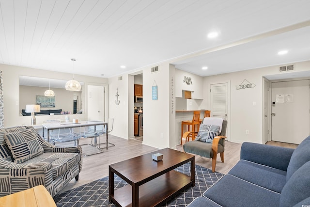 living room featuring recessed lighting, visible vents, dark wood-style flooring, and baseboards