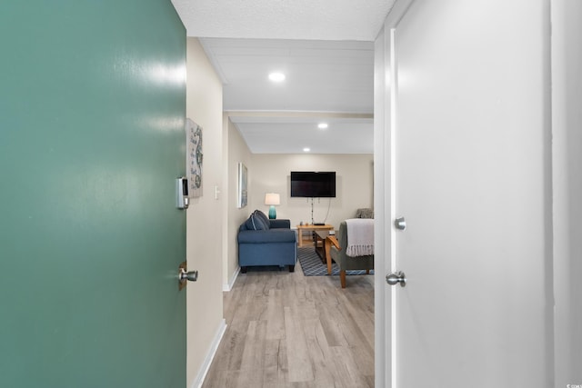 hallway featuring recessed lighting, wood finished floors, and baseboards