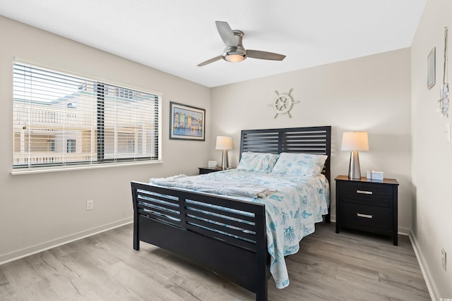 bedroom with wood finished floors, baseboards, and ceiling fan