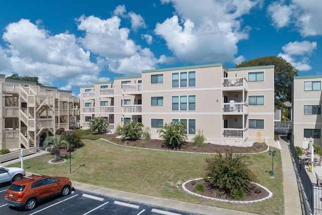 view of building exterior with uncovered parking