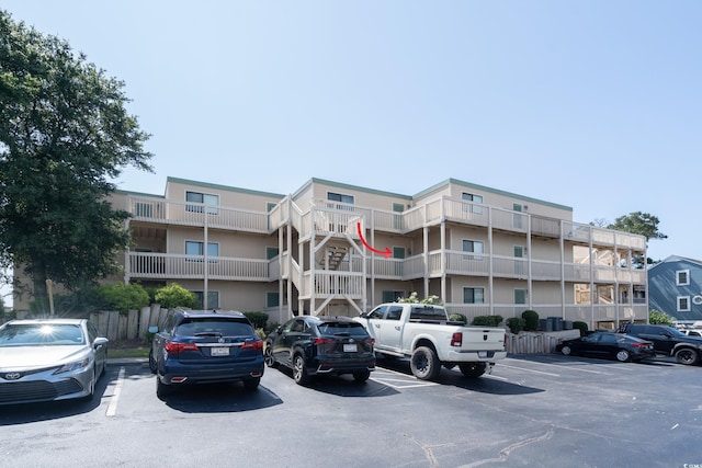 view of building exterior with uncovered parking