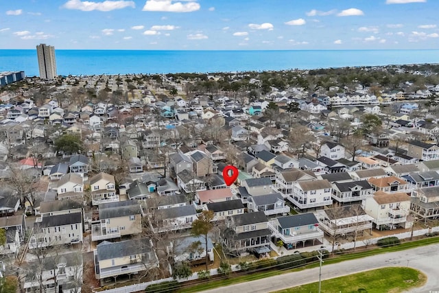 drone / aerial view with a water view and a residential view