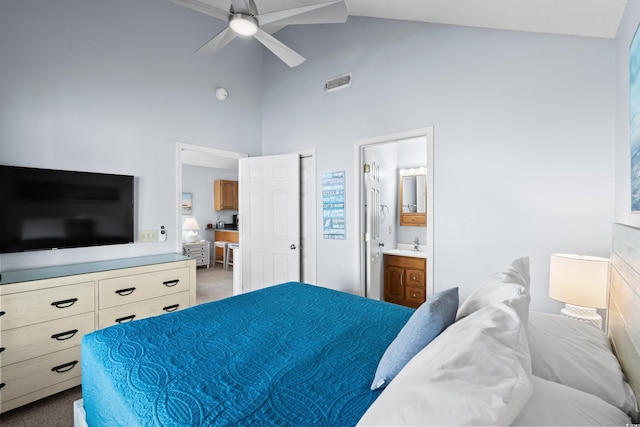 bedroom featuring visible vents, ensuite bathroom, carpet, high vaulted ceiling, and a sink