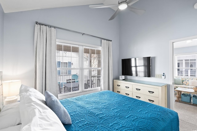 carpeted bedroom with ceiling fan and vaulted ceiling