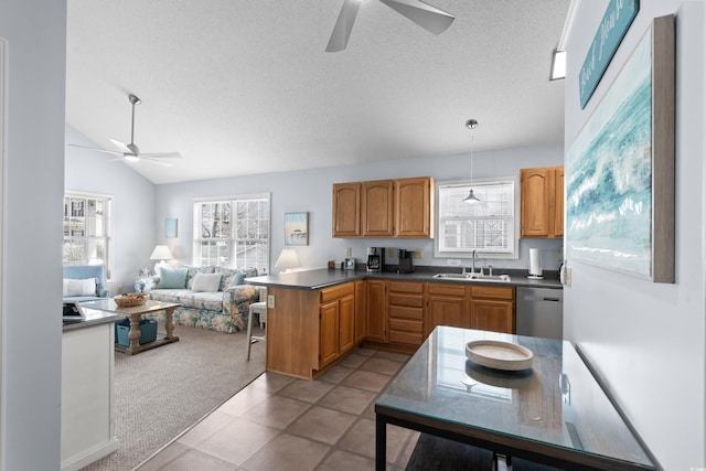 kitchen featuring light carpet, vaulted ceiling, a sink, dishwasher, and a peninsula