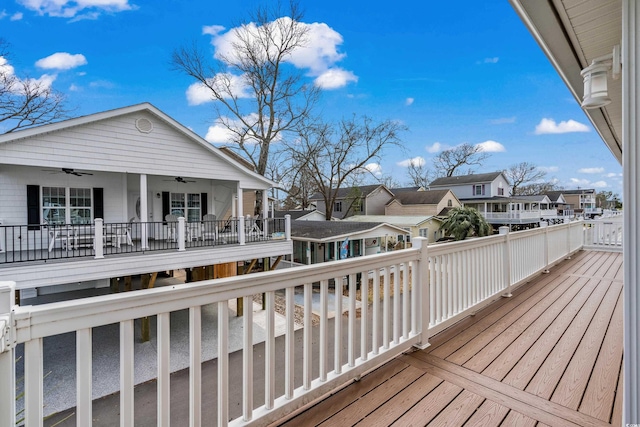 deck featuring ceiling fan and a residential view