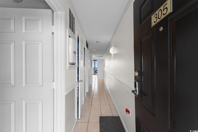 hallway featuring light tile patterned flooring and visible vents