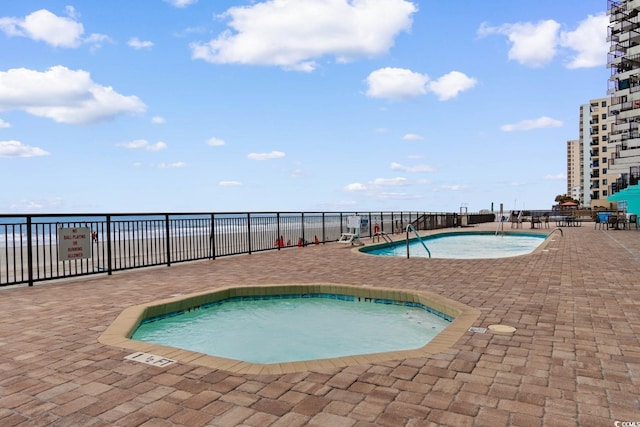 community pool featuring a patio and fence