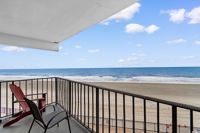 balcony featuring a beach view and a water view