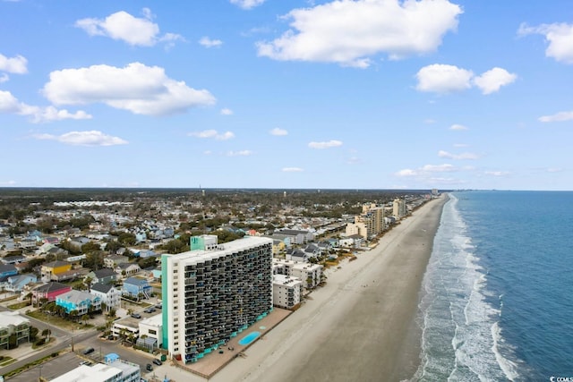 aerial view featuring a city view, a water view, and a beach view