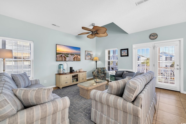 tiled living room featuring baseboards, visible vents, and a ceiling fan