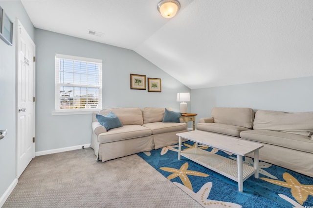 living room with vaulted ceiling, carpet floors, visible vents, and baseboards